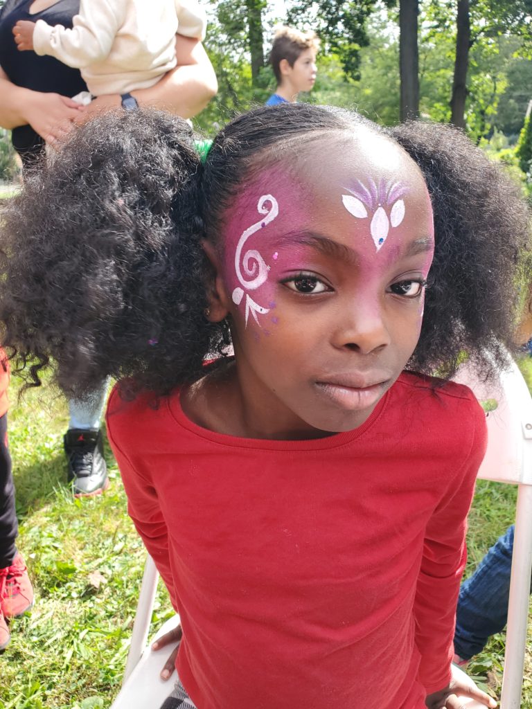 Girl with face paint looking at the camera